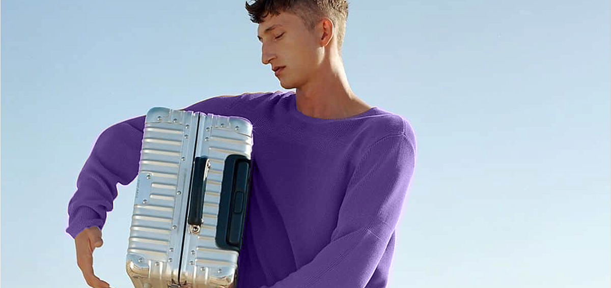 Мужчина с чемоданом в руках оформил страхование от задержки или отмены рейса перед путешествием